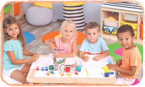 group of children sitting at table doing art